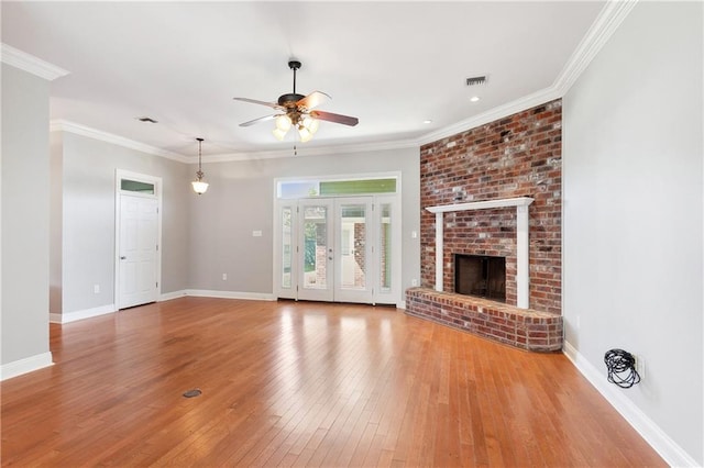 unfurnished living room featuring a fireplace, ceiling fan, hardwood / wood-style floors, and ornamental molding