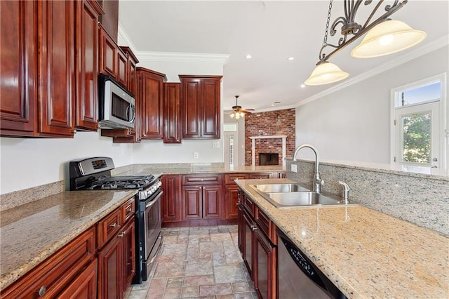 kitchen with ornamental molding, sink, pendant lighting, and appliances with stainless steel finishes