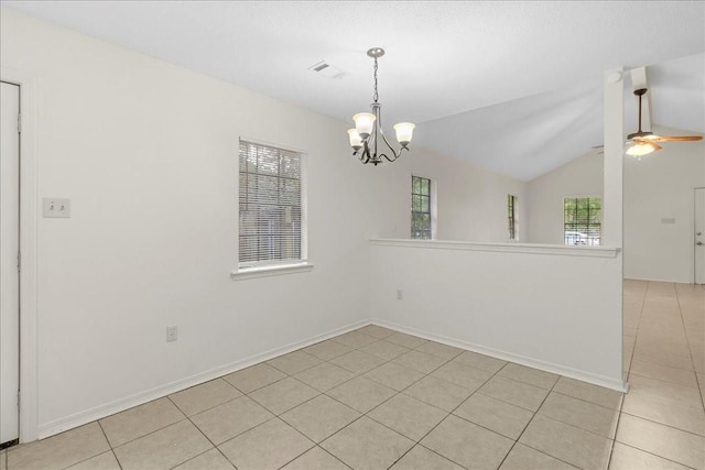 tiled spare room featuring ceiling fan with notable chandelier and vaulted ceiling