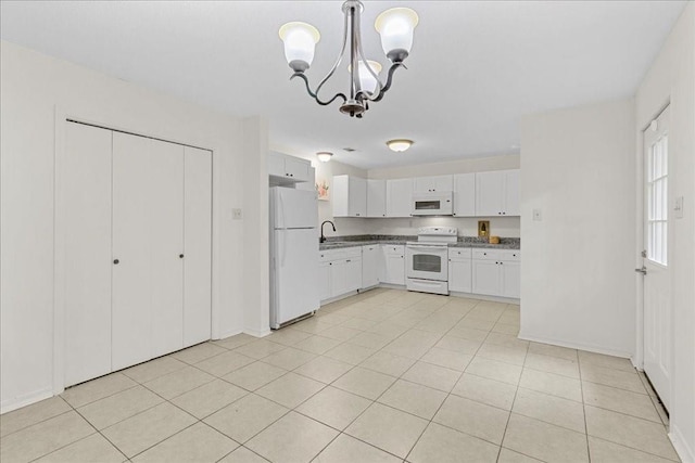 kitchen with white appliances, sink, pendant lighting, an inviting chandelier, and white cabinetry