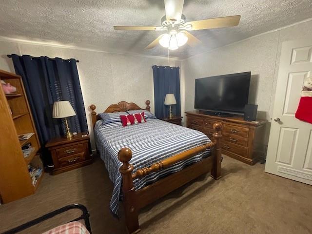 carpeted bedroom featuring ceiling fan, a textured ceiling, and a textured wall