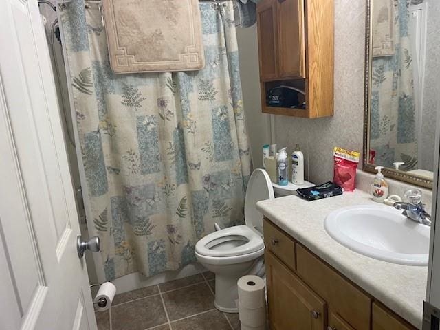 bathroom featuring toilet, vanity, and tile patterned floors