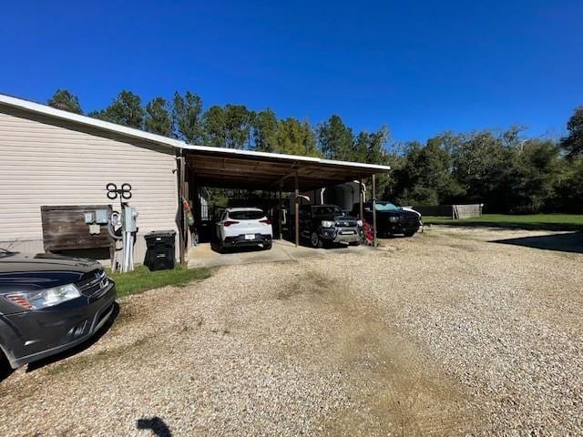 view of parking featuring an attached carport and driveway