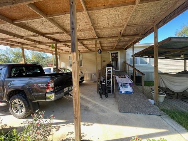 view of vehicle parking with a carport