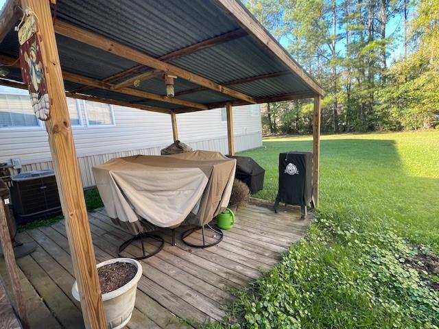 wooden deck with central AC and a lawn