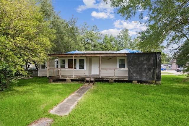 back of house featuring a porch and a lawn