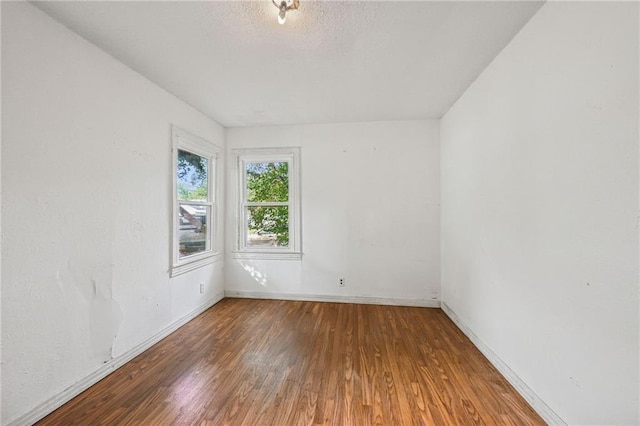 unfurnished room featuring hardwood / wood-style floors