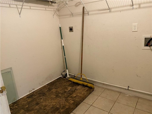 laundry area featuring washer hookup, electric dryer hookup, and light tile patterned flooring