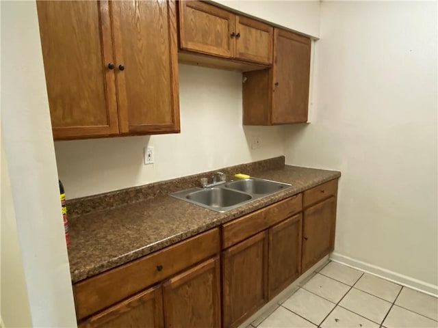 kitchen featuring light tile patterned floors and sink