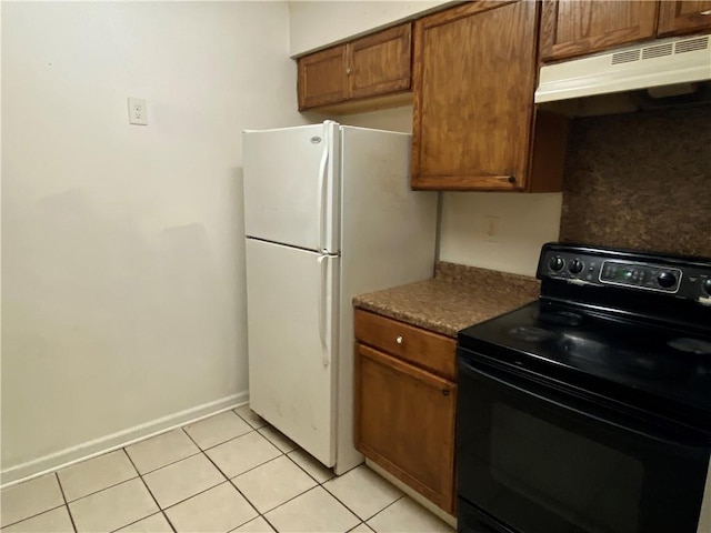 kitchen with backsplash, white fridge, black range with electric stovetop, and light tile patterned flooring