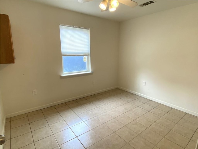 tiled empty room with ceiling fan