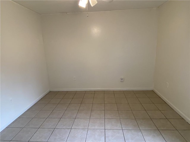 empty room featuring light tile patterned floors and ceiling fan