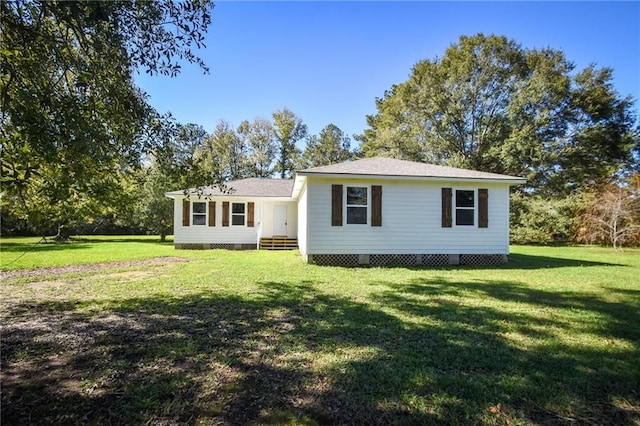 rear view of property with a lawn