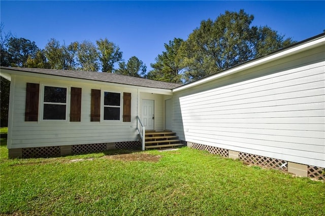 property entrance with a lawn