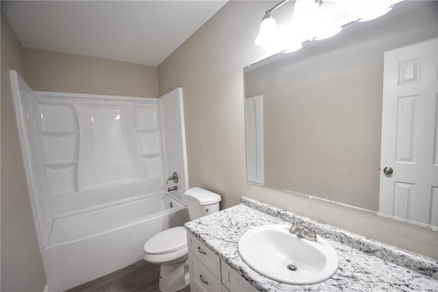 full bathroom featuring vanity, toilet, wood-type flooring, and bathing tub / shower combination