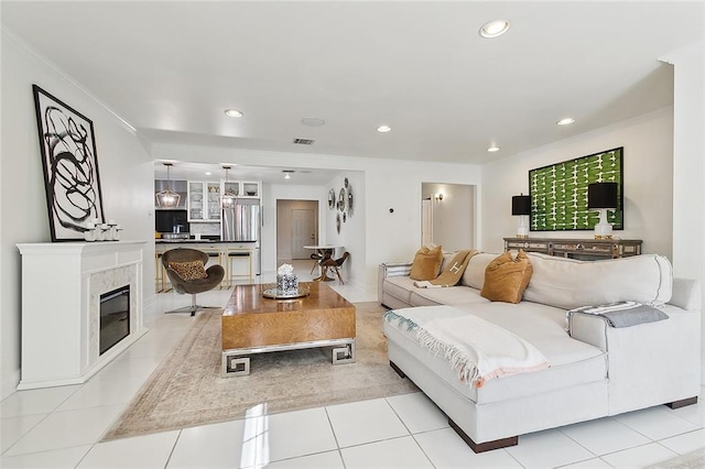 tiled living room with crown molding and a high end fireplace