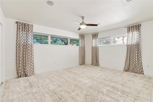 unfurnished bedroom with carpet flooring, multiple windows, and ceiling fan