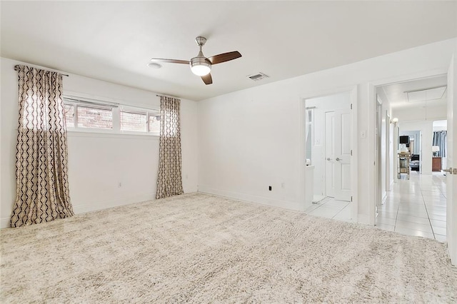 tiled empty room featuring ceiling fan