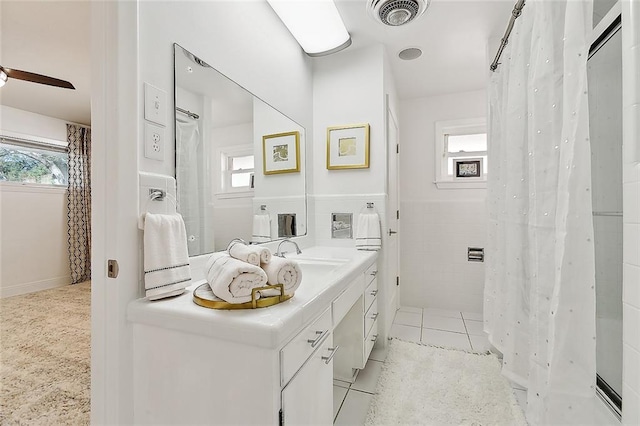 bathroom featuring tile patterned flooring, vanity, and a healthy amount of sunlight