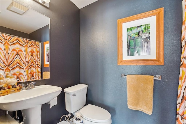 bathroom with toilet and sink