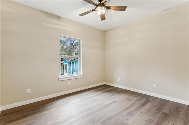 spare room with ceiling fan and wood-type flooring