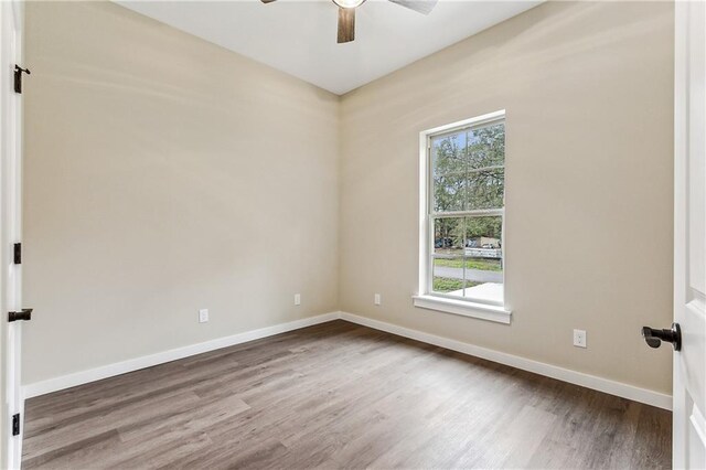 spare room with ceiling fan and hardwood / wood-style flooring