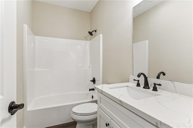 full bathroom featuring toilet, vanity, and bathtub / shower combination