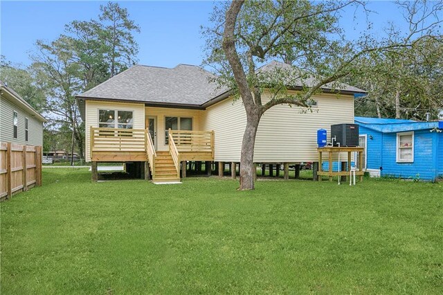 back of property featuring a deck and a yard