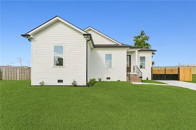 rear view of property with a lawn