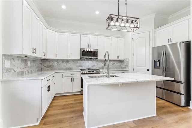 kitchen with a center island with sink, white cabinets, and appliances with stainless steel finishes