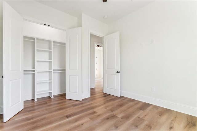 unfurnished bedroom featuring light hardwood / wood-style floors and a closet