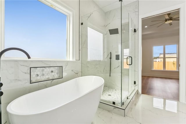 bathroom featuring plus walk in shower, a healthy amount of sunlight, and ceiling fan