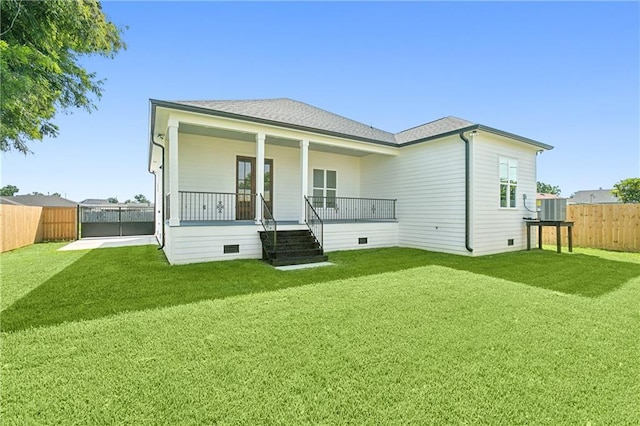 back of property with a porch and a lawn