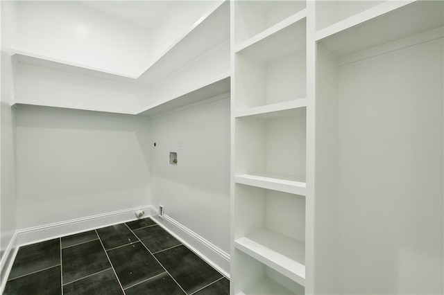 washroom with washer hookup, hookup for an electric dryer, and dark tile patterned floors