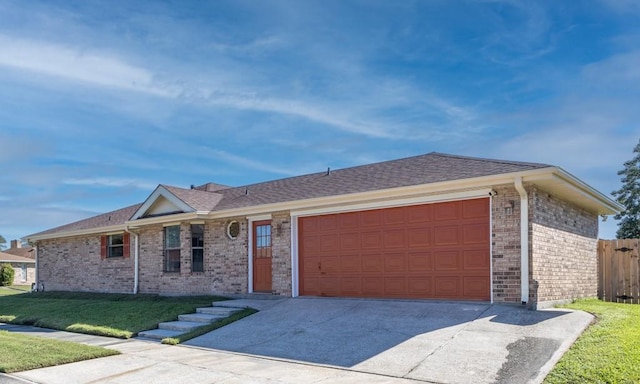 ranch-style home with a garage and a front lawn