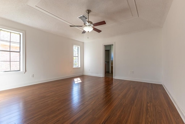 spare room with a textured ceiling, dark hardwood / wood-style floors, and ceiling fan