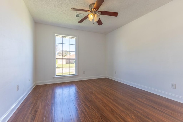 unfurnished room featuring a textured ceiling, ceiling fan, and dark wood-type flooring