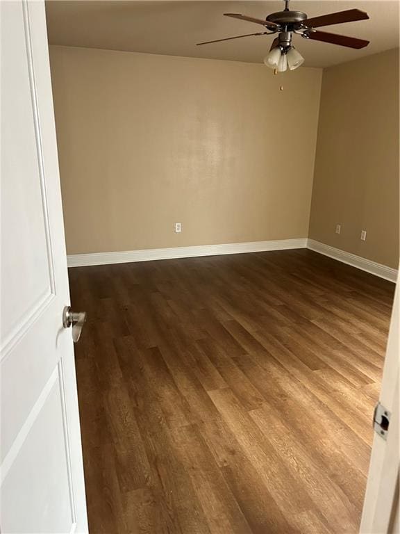 unfurnished room featuring dark hardwood / wood-style flooring and ceiling fan