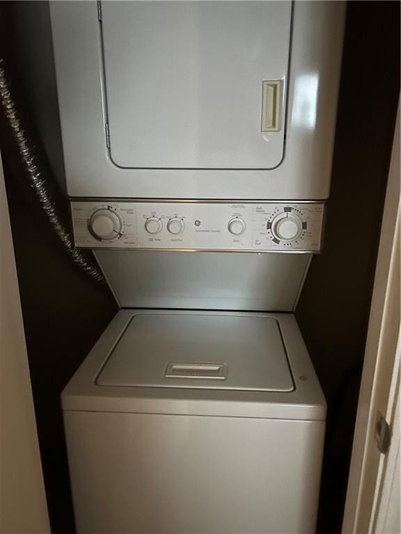 washroom featuring stacked washing maching and dryer