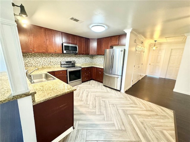 kitchen featuring sink, tasteful backsplash, light stone counters, kitchen peninsula, and stainless steel appliances