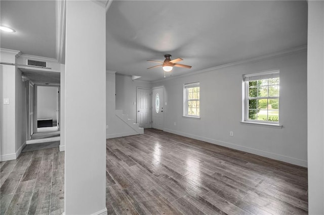 unfurnished living room featuring ornamental molding, ceiling fan, and dark wood-type flooring