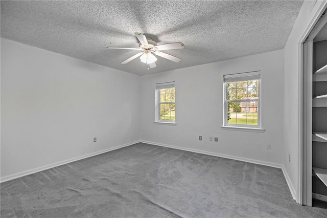 spare room featuring carpet flooring, ceiling fan, and a textured ceiling