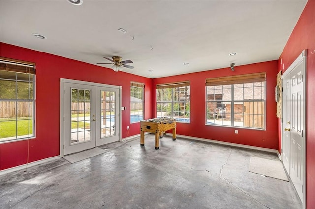 interior space featuring ceiling fan, concrete flooring, and french doors