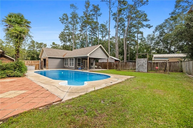 view of swimming pool featuring a lawn and a patio area