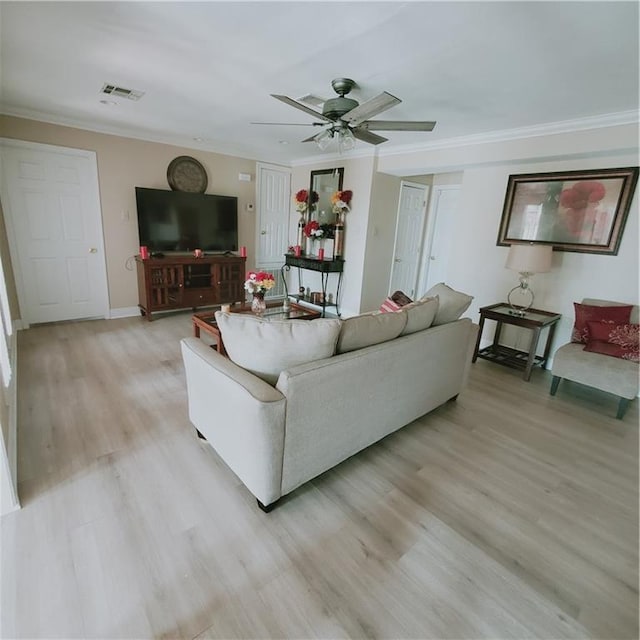 living room with ceiling fan, light wood-type flooring, and crown molding