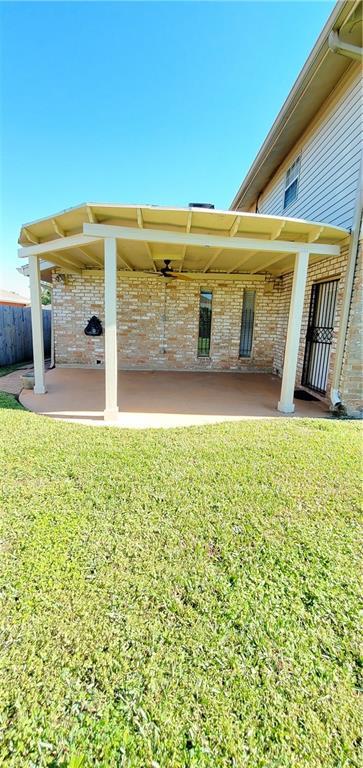 rear view of house with a yard and a patio