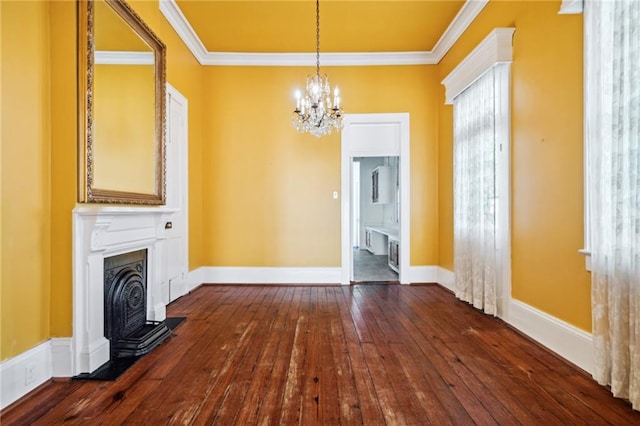 unfurnished living room featuring a wood stove, crown molding, a chandelier, and dark hardwood / wood-style floors