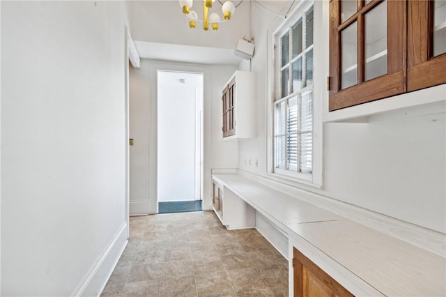 mudroom featuring a notable chandelier