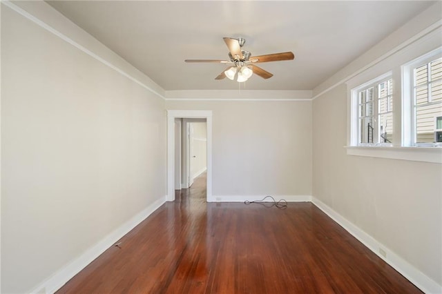 spare room with ceiling fan and dark hardwood / wood-style flooring