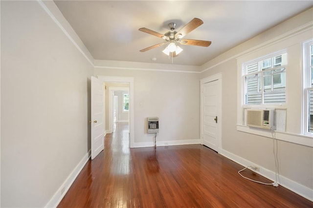 unfurnished room with heating unit, dark hardwood / wood-style floors, and ceiling fan